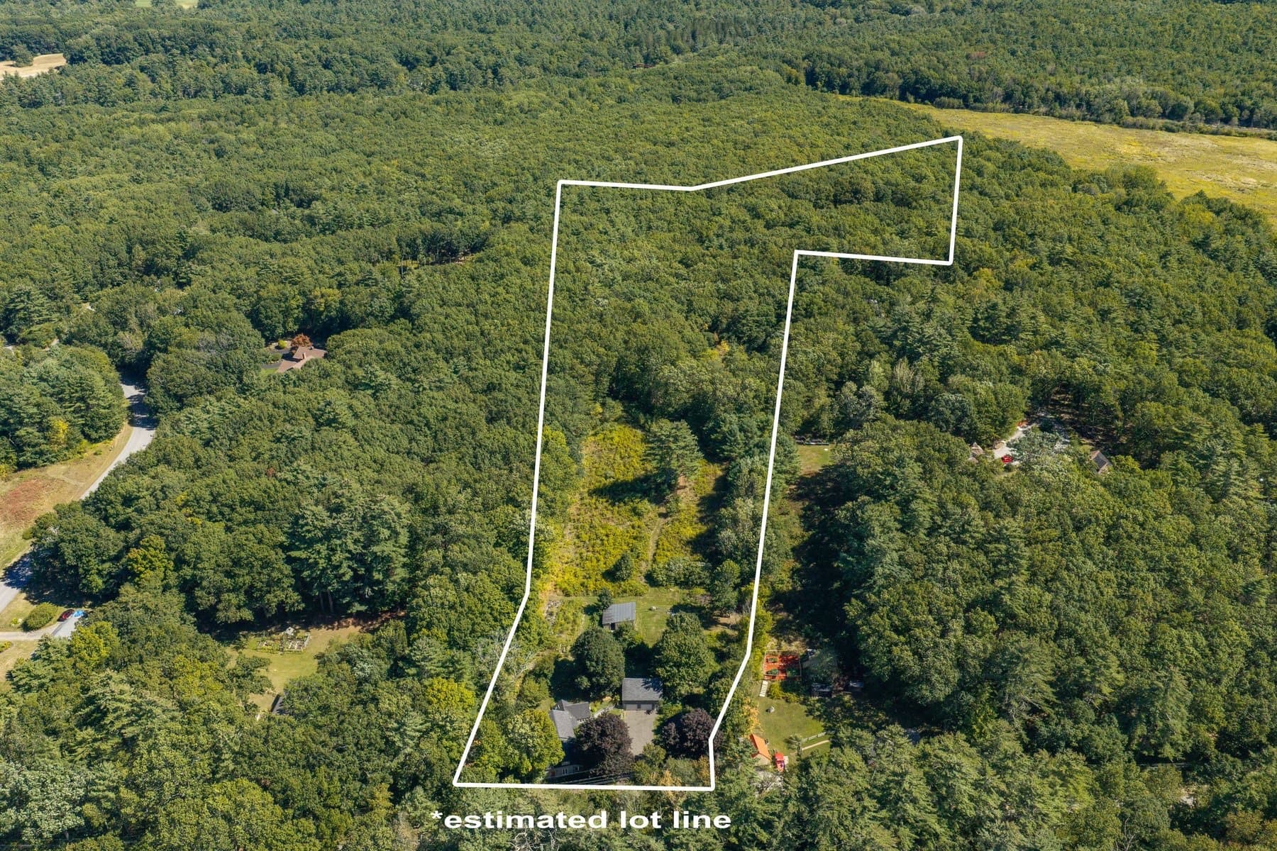 The wooded 13.8 acre lot from the air, with the photographer's estimated lot line drawn in